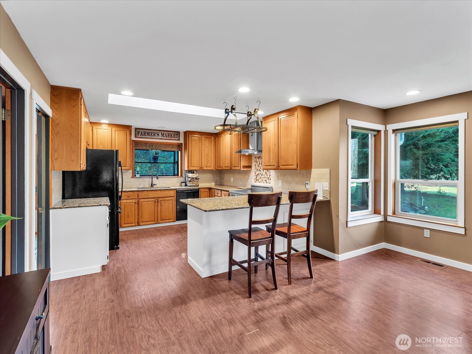 7417 Silvana Terrace Road Stanwood, WA 98292 - Photo 15 of 38 a kitchen with a table chairs refrigerator and microwave