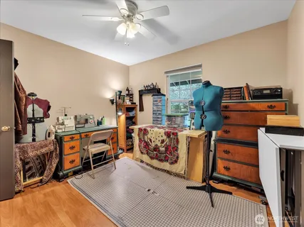 a view of a bedroom with workspace and windows
