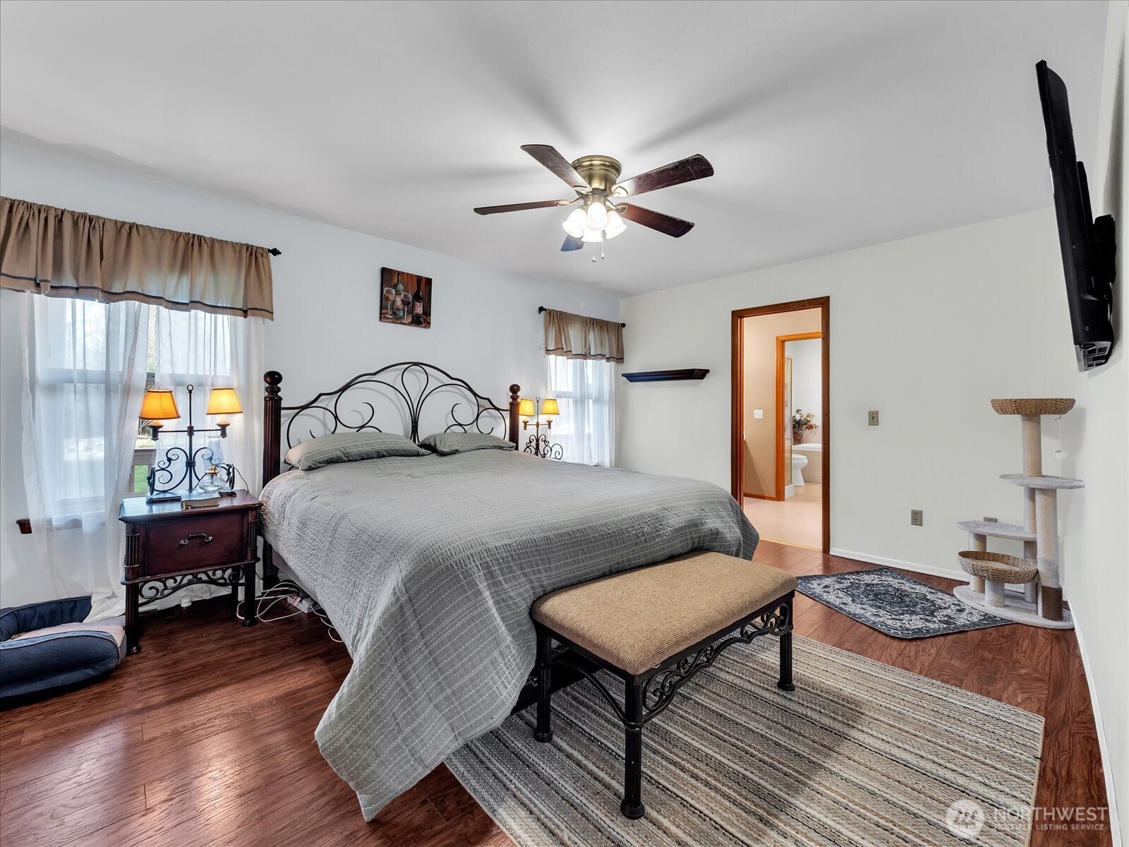 7417 Silvana Terrace Road Stanwood, WA 98292 - Photo 21 of 38 a bedroom with a bed a dresser and wooden floor
