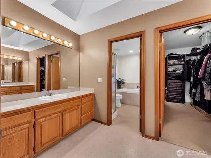 a spacious bathroom with a shower and a sink