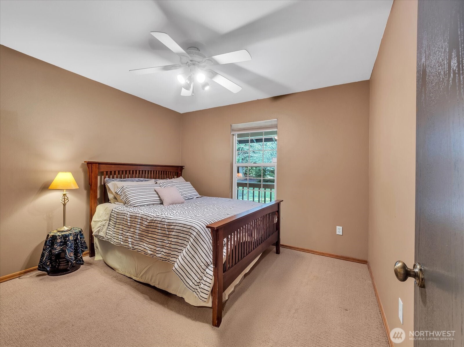 7417 Silvana Terrace Road Stanwood, WA 98292 - Photo 24 of 38 a bedroom with a bed and a lamp