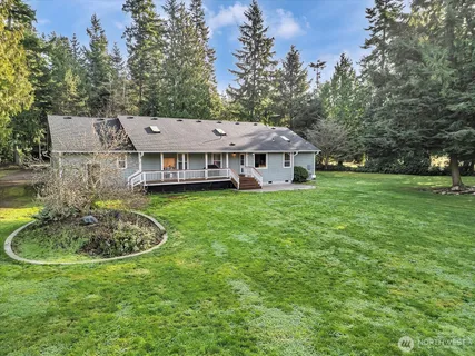 a aerial view of a house with a yard table and chairs