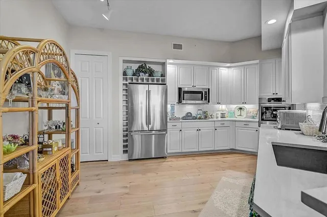 a bedroom with a large bed and a chandelier