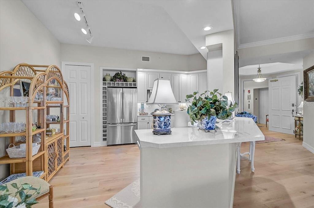 409 North Point Road, Unit 902 Osprey, FL 34229 - Photo 17 of 59 a kitchen with stainless steel appliances kitchen island granite countertop a refrigerator and a sink