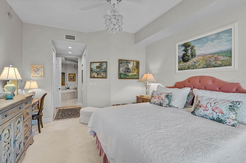 409 North Point Road, Unit 902 Osprey, FL 34229 - Photo 19 of 59 a bedroom with a large bed and a chandelier