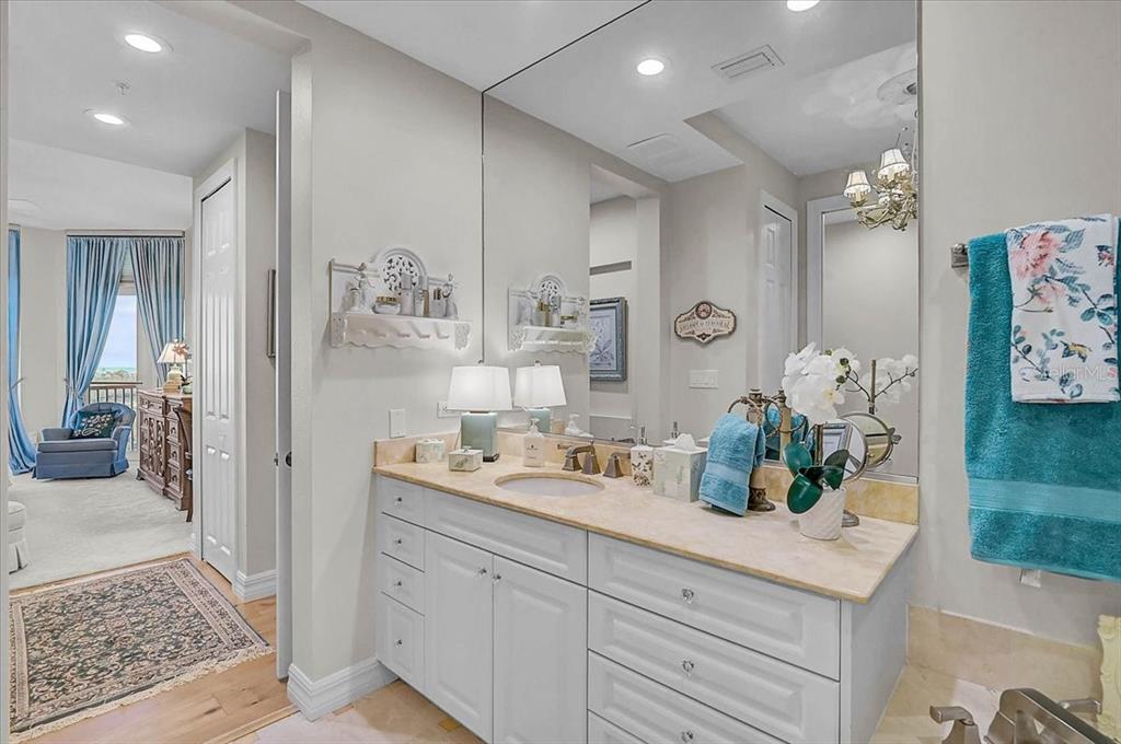 409 North Point Road, Unit 902 Osprey, FL 34229 - Photo 22 of 59 a spacious bathroom with a granite countertop sink a mirror and shower