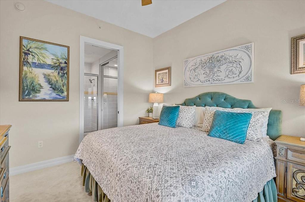 409 North Point Road, Unit 902 Osprey, FL 34229 - Photo 27 of 59 a bedroom with a large bed and a couch