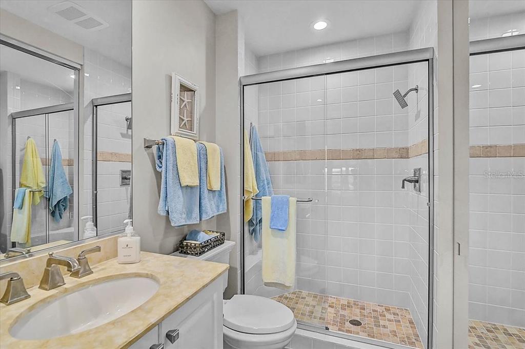409 North Point Road, Unit 902 Osprey, FL 34229 - Photo 28 of 59 a bathroom with a sink toilet double vanity and shower