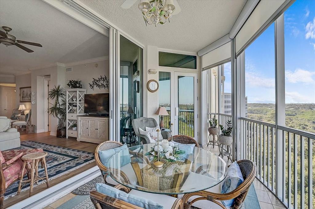409 North Point Road, Unit 902 Osprey, FL 34229 - Photo 33 of 59 a dining room with furniture a chandelier and wooden floor