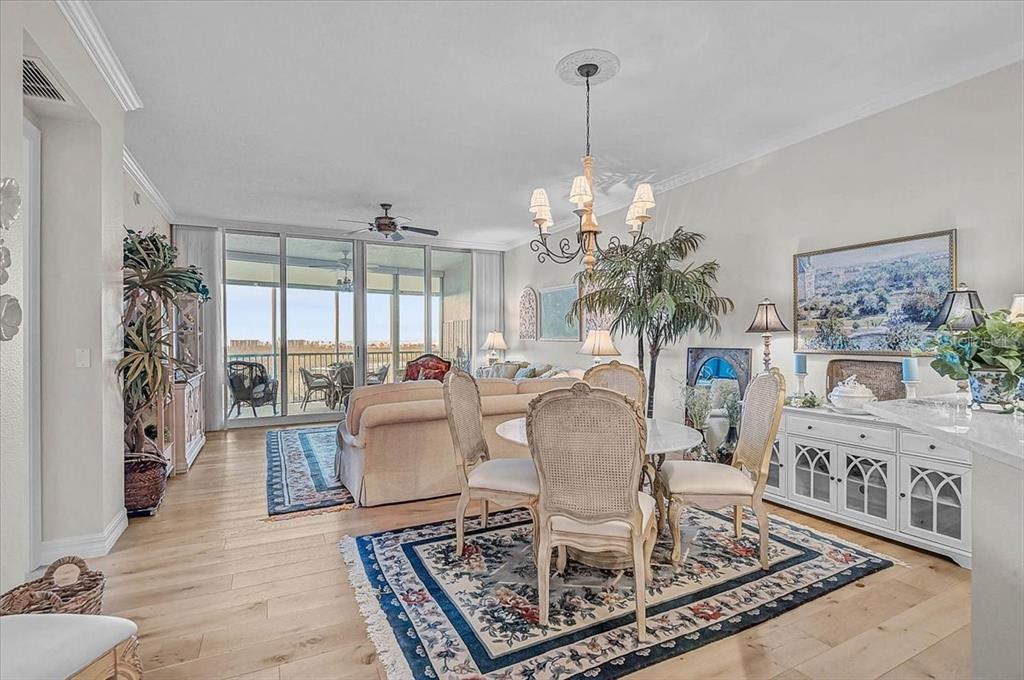 409 North Point Road, Unit 902 Osprey, FL 34229 - Photo 8 of 59 a living room with furniture and a chandelier