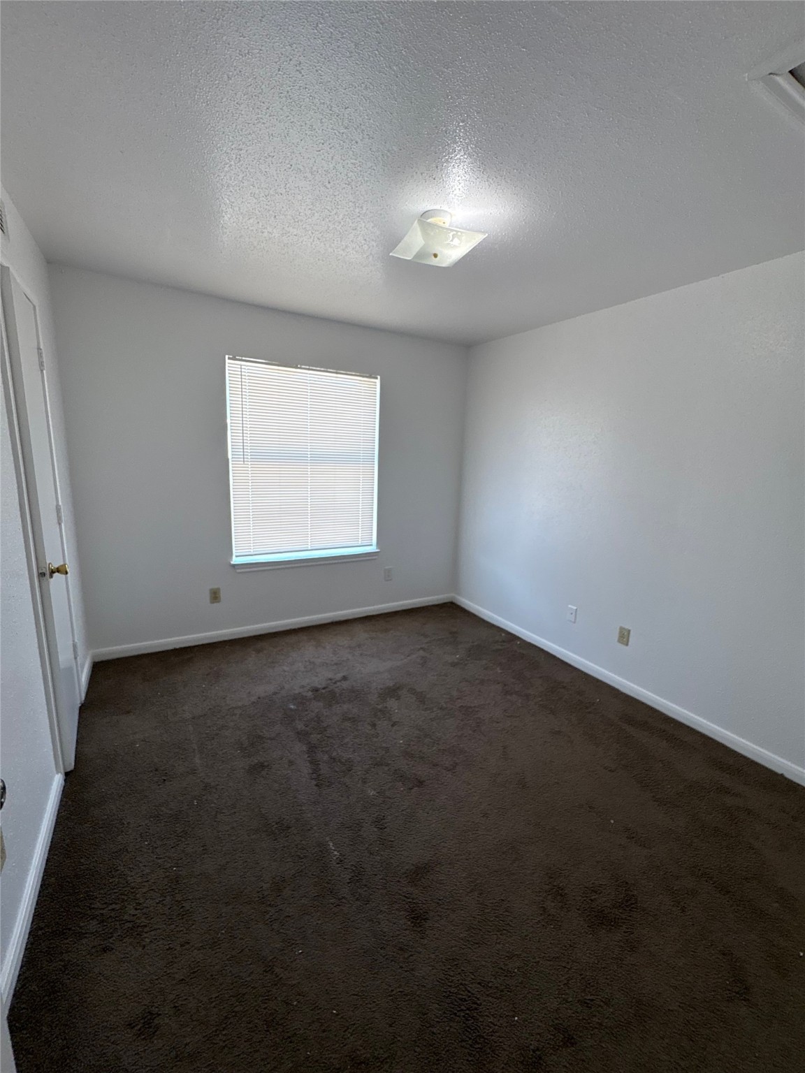 7201 Hallshire Drive, Unit 222 Houston, TX 77016 - Photo 11 of 20 an empty room with a empty space and windows