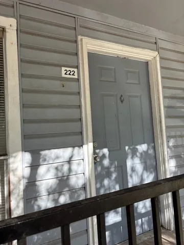 a view of an empty room with a kitchen