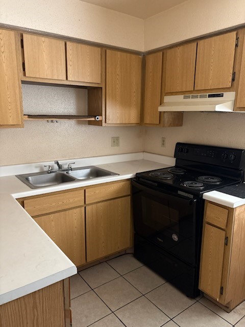 7201 Hallshire Drive, Unit 222 Houston, TX 77016 - Photo 17 of 20 a kitchen with granite countertop cabinets and a stove top oven