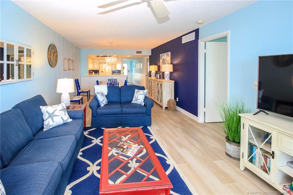 20 Northeast Plantation Road, Unit 205 Jensen Beach, FL 34957 - Photo 12 of 30 a living room with furniture and a flat screen tv