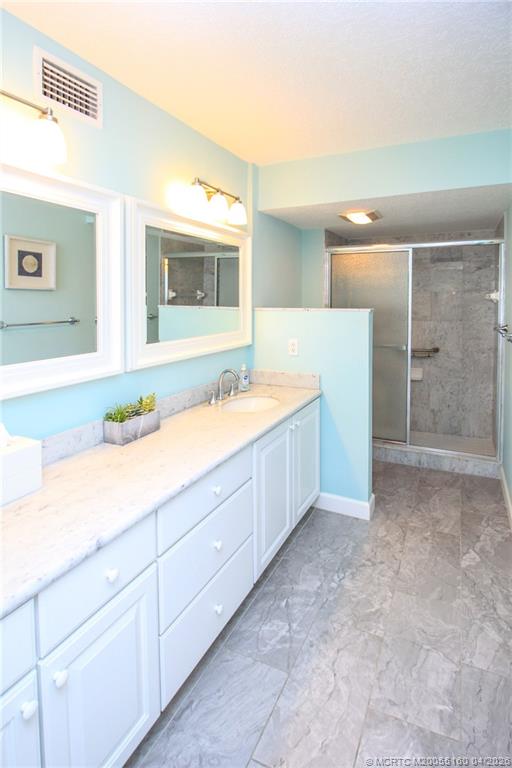 20 Northeast Plantation Road, Unit 205 Jensen Beach, FL 34957 - Photo 19 of 30 a bathroom with a sink and a mirror
