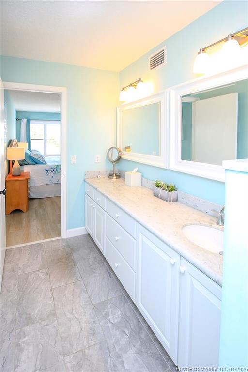 20 Northeast Plantation Road, Unit 205 Jensen Beach, FL 34957 - Photo 20 of 30 a en suite bathroom with a double vanity sink mirror and