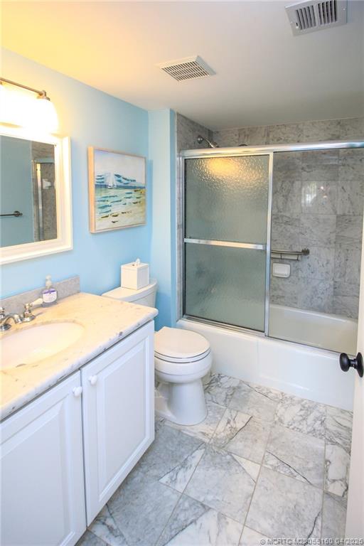 20 Northeast Plantation Road, Unit 205 Jensen Beach, FL 34957 - Photo 24 of 30 a bathroom with a granite countertop sink toilet and shower