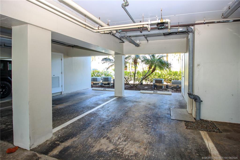 20 Northeast Plantation Road, Unit 205 Jensen Beach, FL 34957 - Photo 28 of 30 a view of a garage