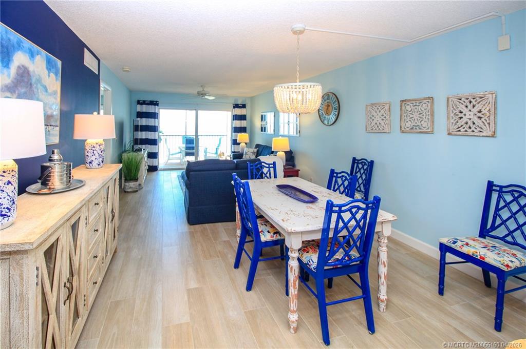 20 Northeast Plantation Road, Unit 205 Jensen Beach, FL 34957 - Photo 7 of 30 a view of a dining room with furniture window and wooden floor