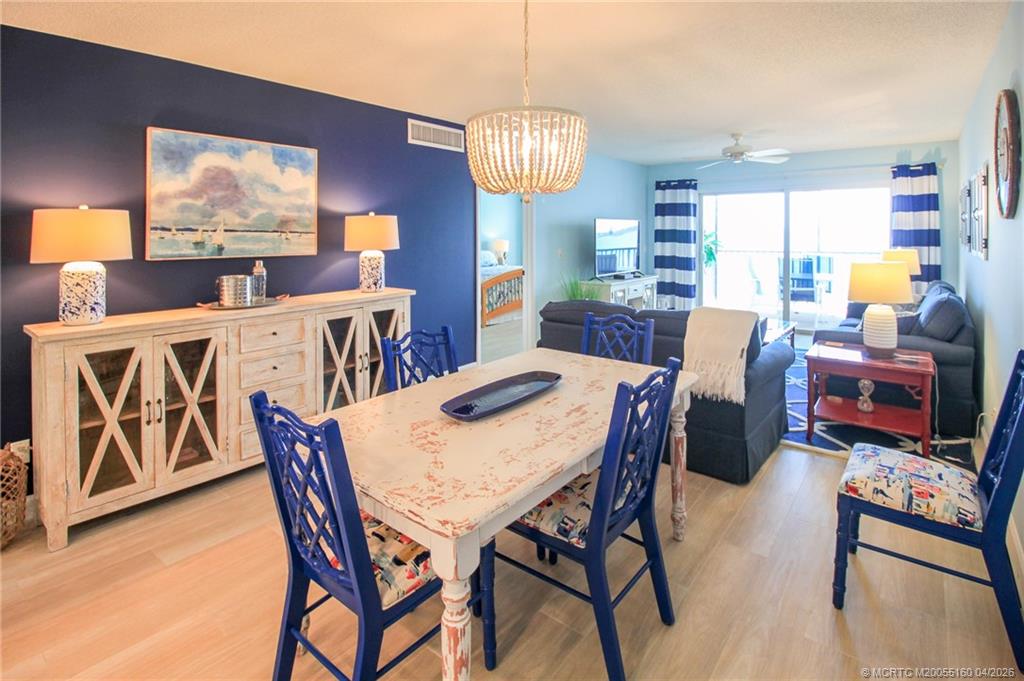 20 Northeast Plantation Road, Unit 205 Jensen Beach, FL 34957 - Photo 8 of 30 a view of a dining room with furniture window and wooden floor