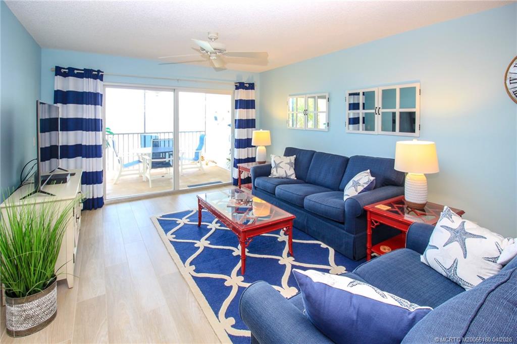 20 Northeast Plantation Road, Unit 205 Jensen Beach, FL 34957 - Photo 9 of 30 a living room with furniture and a potted plant