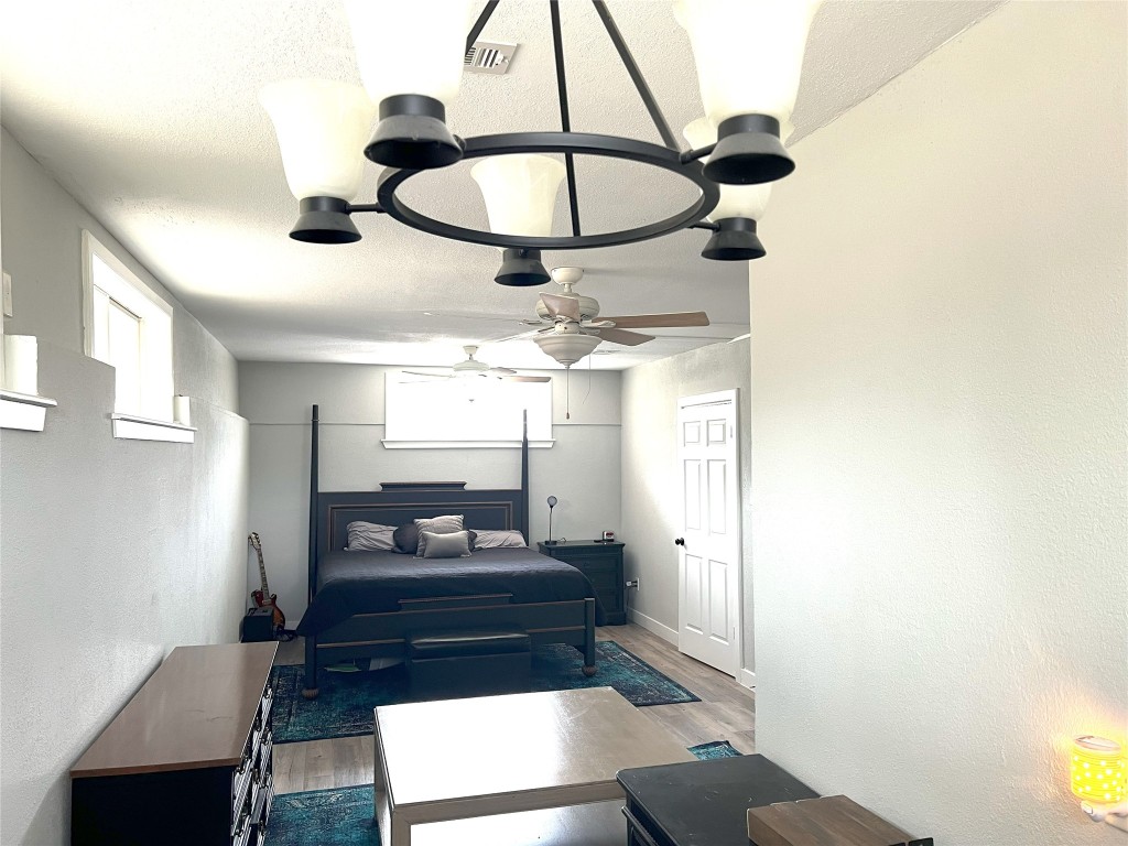 128 Skyview Terrace, Unit B Leander, TX 78641 - Photo 11 of 24 a living room with furniture and a chandelier