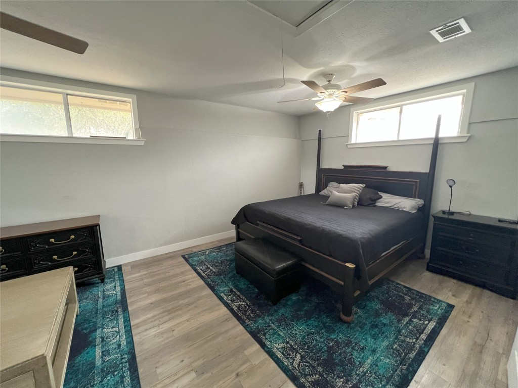 128 Skyview Terrace, Unit B Leander, TX 78641 - Photo 4 of 24 a bedroom with a bed and a dresser