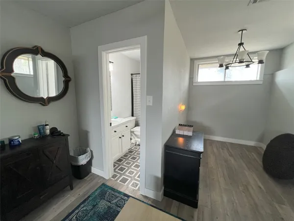 a living room with furniture and a mirror