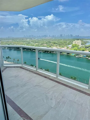 a view of balcony with wooden floor and fence