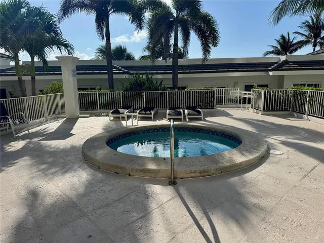 a view of swimming pool with outdoor seating and plants