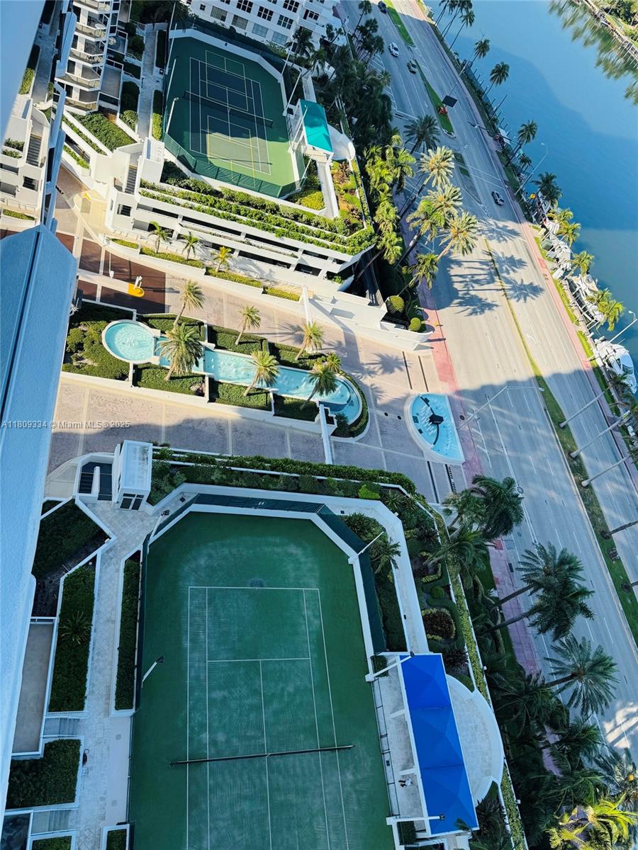 4779 Collins Avenue, Unit 2106 Miami Beach, FL 33140 - Photo 18 of 25 a view of swimming pool with outdoor seating and plants