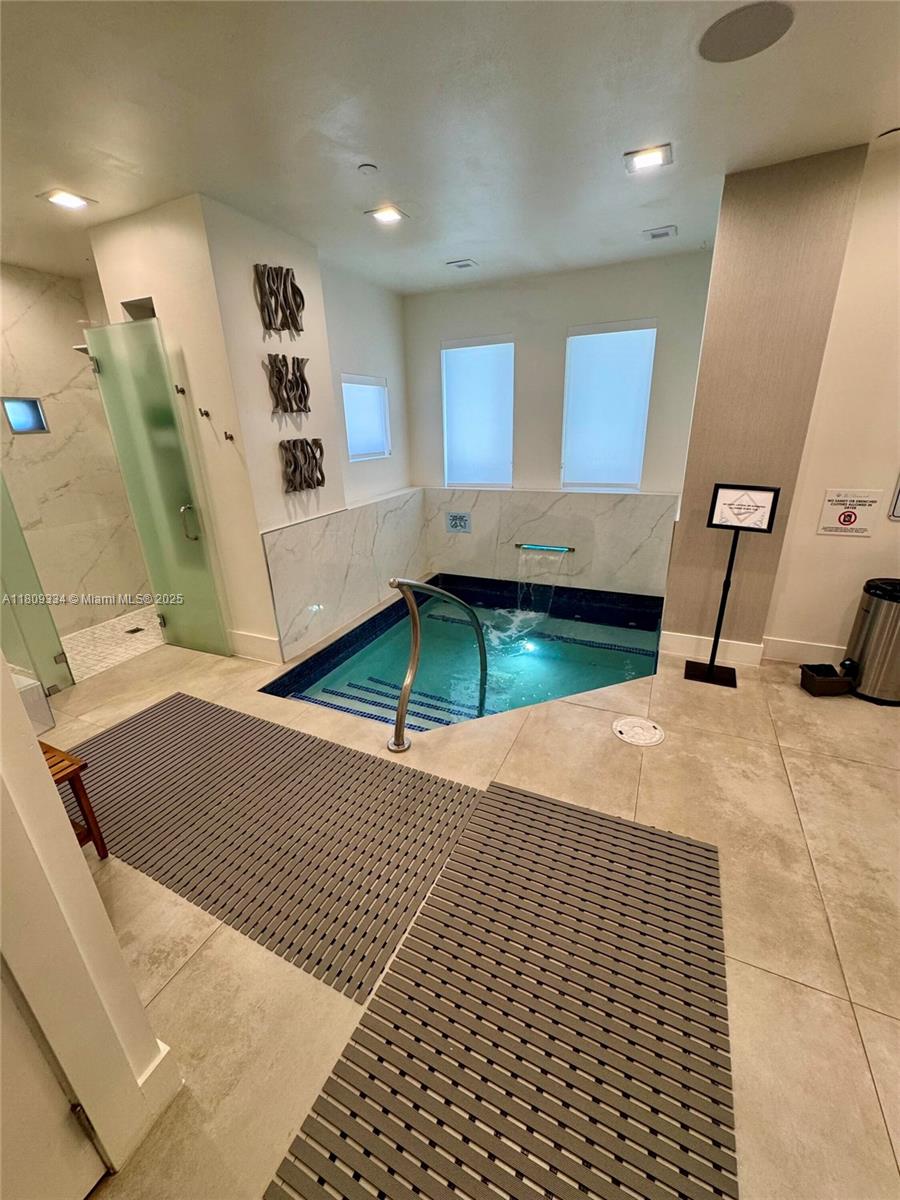 4779 Collins Avenue, Unit 2106 Miami Beach, FL 33140 - Photo 20 of 25 a room with window and a table