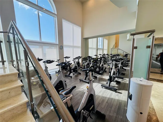 a room with lots of furniture and a kitchen view