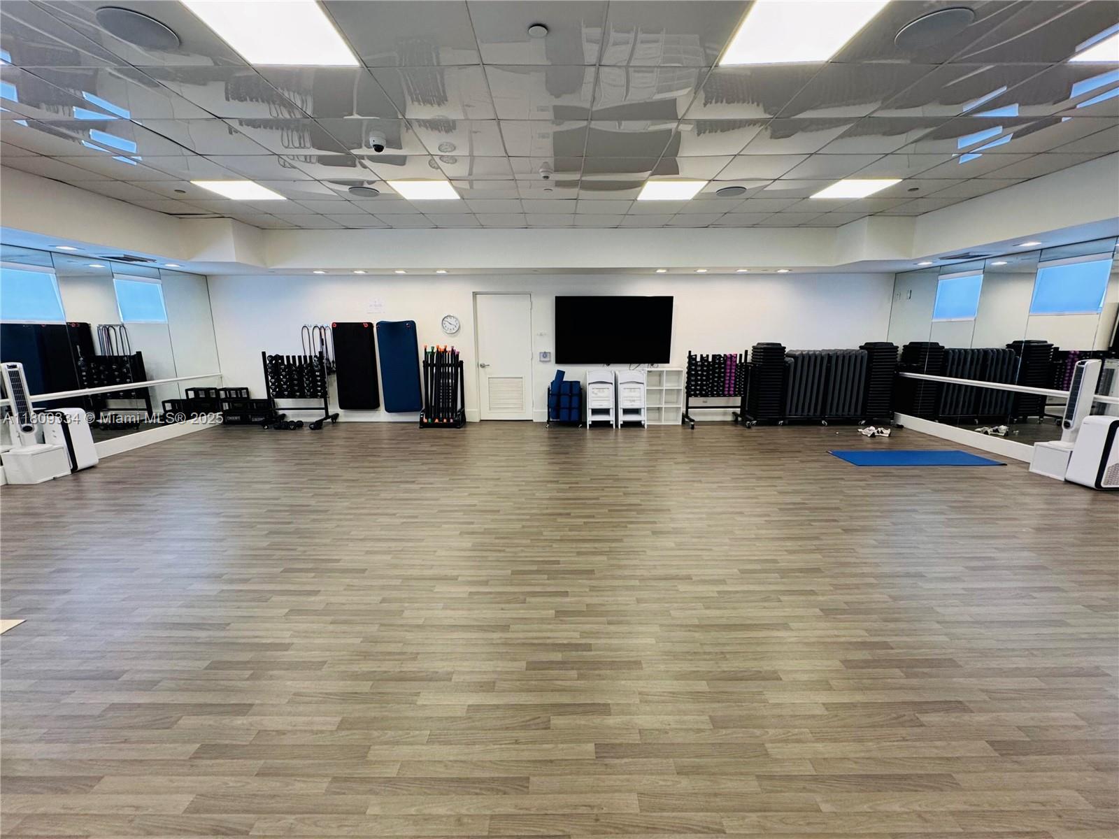 4779 Collins Avenue, Unit 2106 Miami Beach, FL 33140 - Photo 24 of 25 a room with lots of furniture and a kitchen view