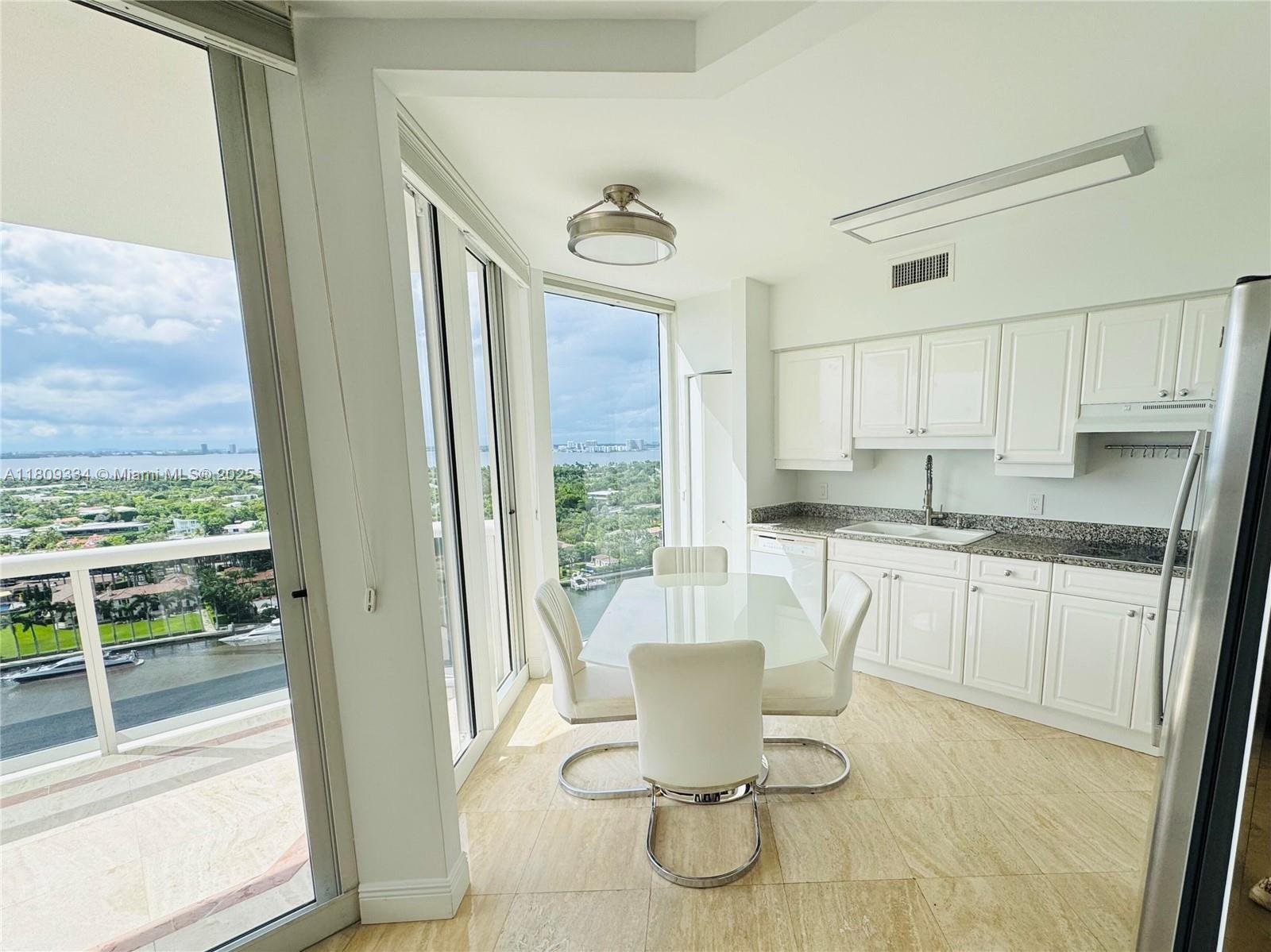 4779 Collins Avenue, Unit 2106 Miami Beach, FL 33140 - Photo 3 of 25 a kitchen with a stove a sink and a view of living room