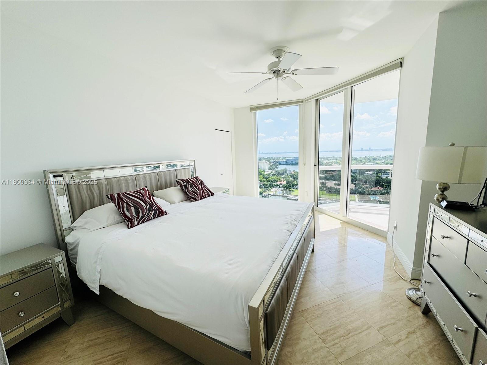 4779 Collins Avenue, Unit 2106 Miami Beach, FL 33140 - Photo 4 of 25 a bedroom with a large bed and a large window