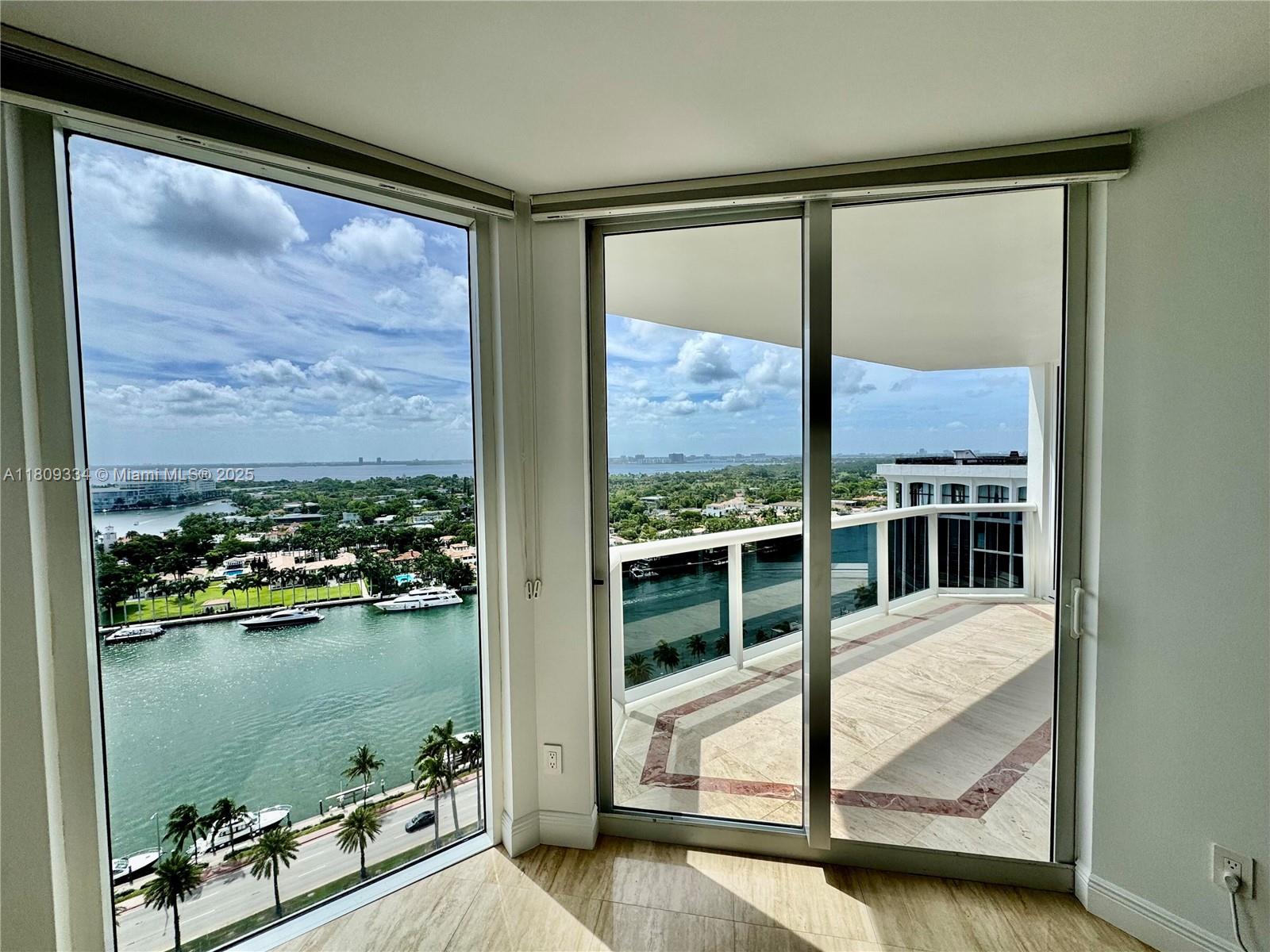 4779 Collins Avenue, Unit 2106 Miami Beach, FL 33140 - Photo 9 of 25 a view of a balcony with chair and floor to ceiling window