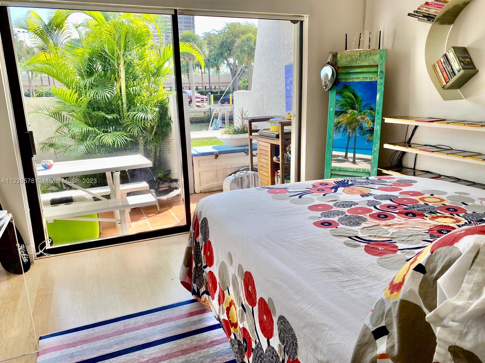 1650 Northeast 115th Street, Unit 102 Miami, FL 33181 - Photo 11 of 35 a bedroom with a bed and a window