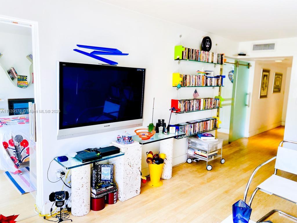 1650 Northeast 115th Street, Unit 102 Miami, FL 33181 - Photo 19 of 35 a room with furniture and a flat screen tv