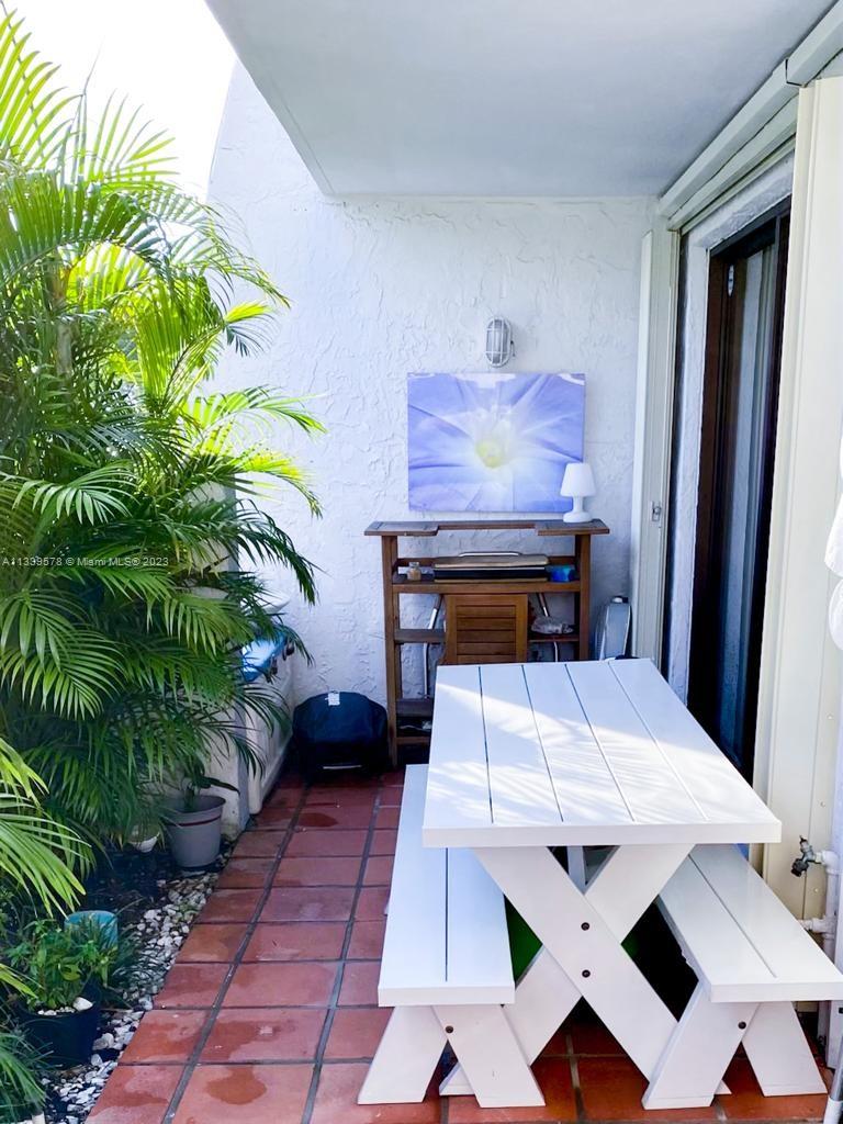 1650 Northeast 115th Street, Unit 102 Miami, FL 33181 - Photo 21 of 35 a bed room with a bed and a potted plant
