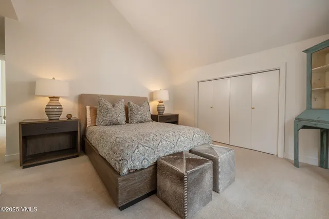 a bedroom with a bed and a lamp on table