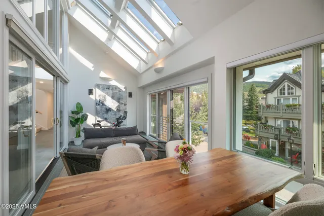 a view of a dining room with furniture large windows and wooden floor
