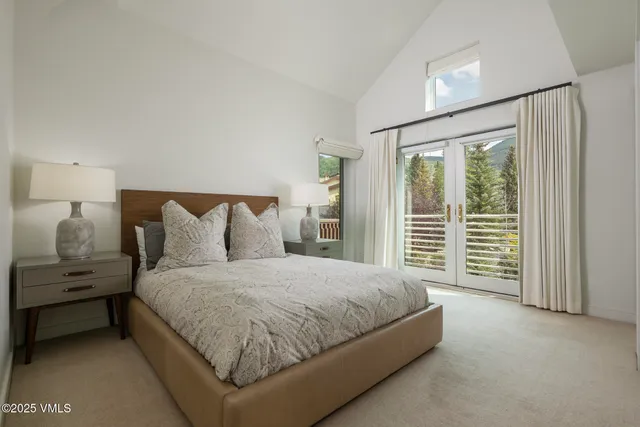 a spacious bedroom with a bed and a window