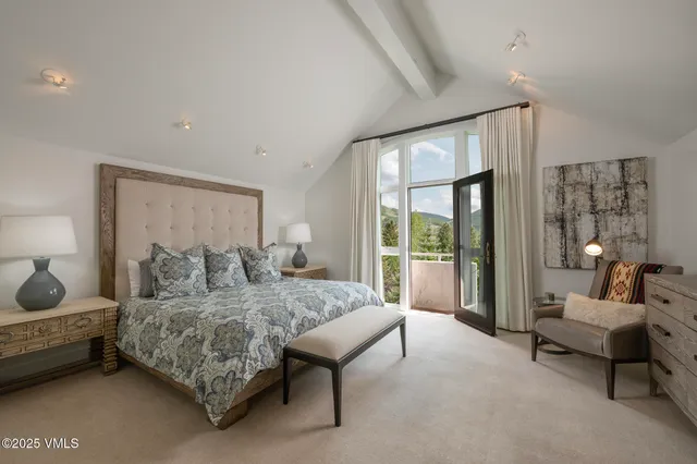 a bedroom with a bed and large window