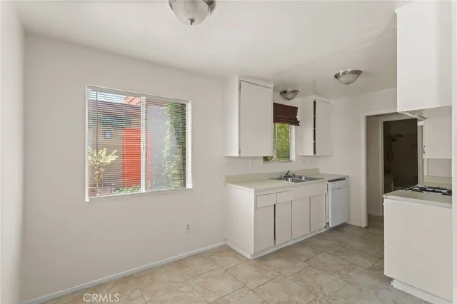 a kitchen with cabinets and steel stainless steel appliances
