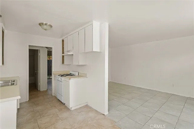 a kitchen that has a sink and a stove
