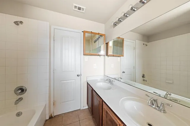 a bathroom with a granite countertop sink mirror and double