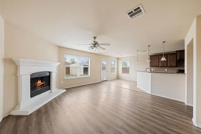 a view of a kitchen with a sink a kitchen and a refrigerator