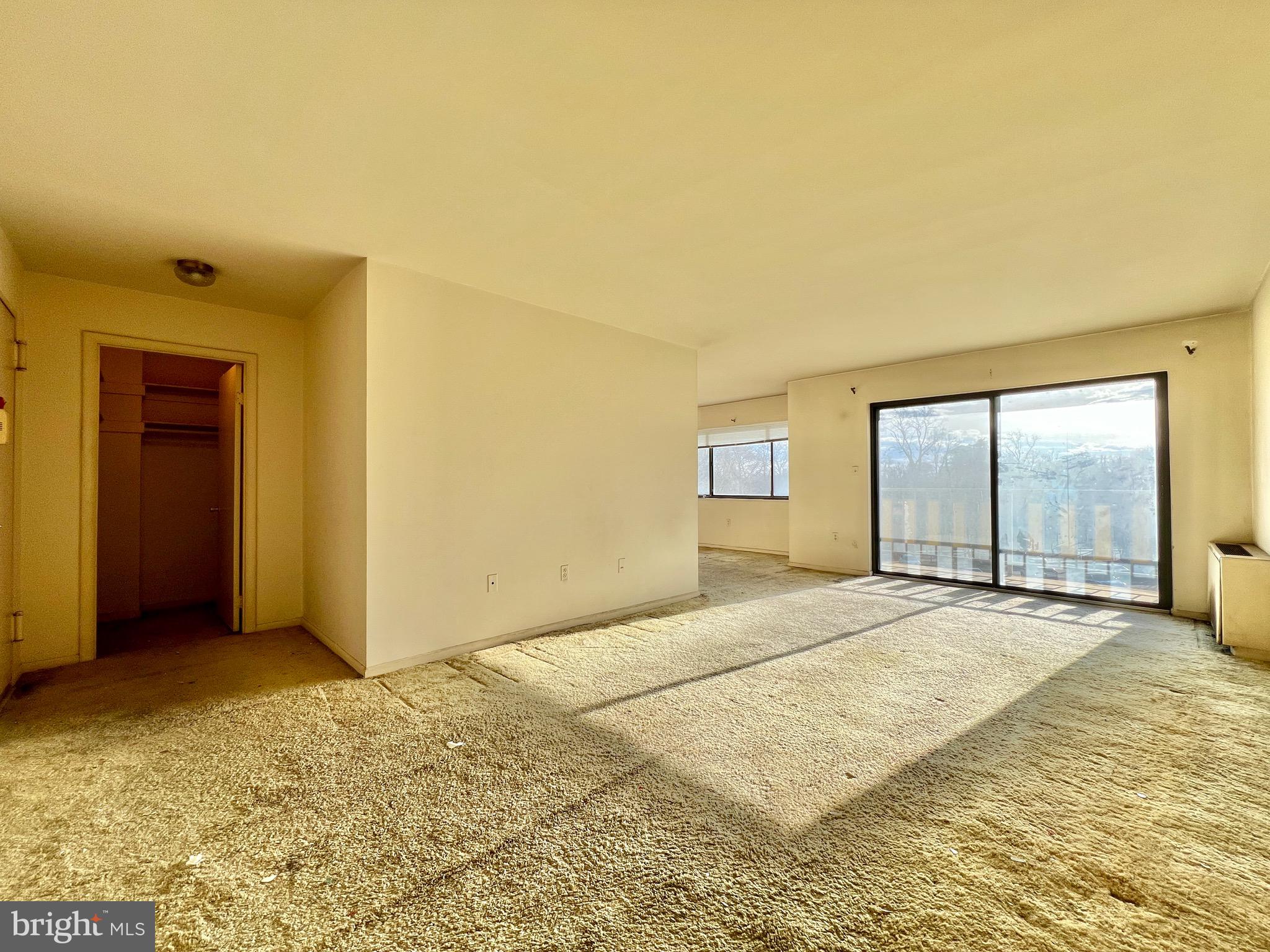 8830 Piney Branch Road, Unit 402 Silver Spring, MD 20903 - Photo 1 of 23 a view of an empty room with window and a bathroom