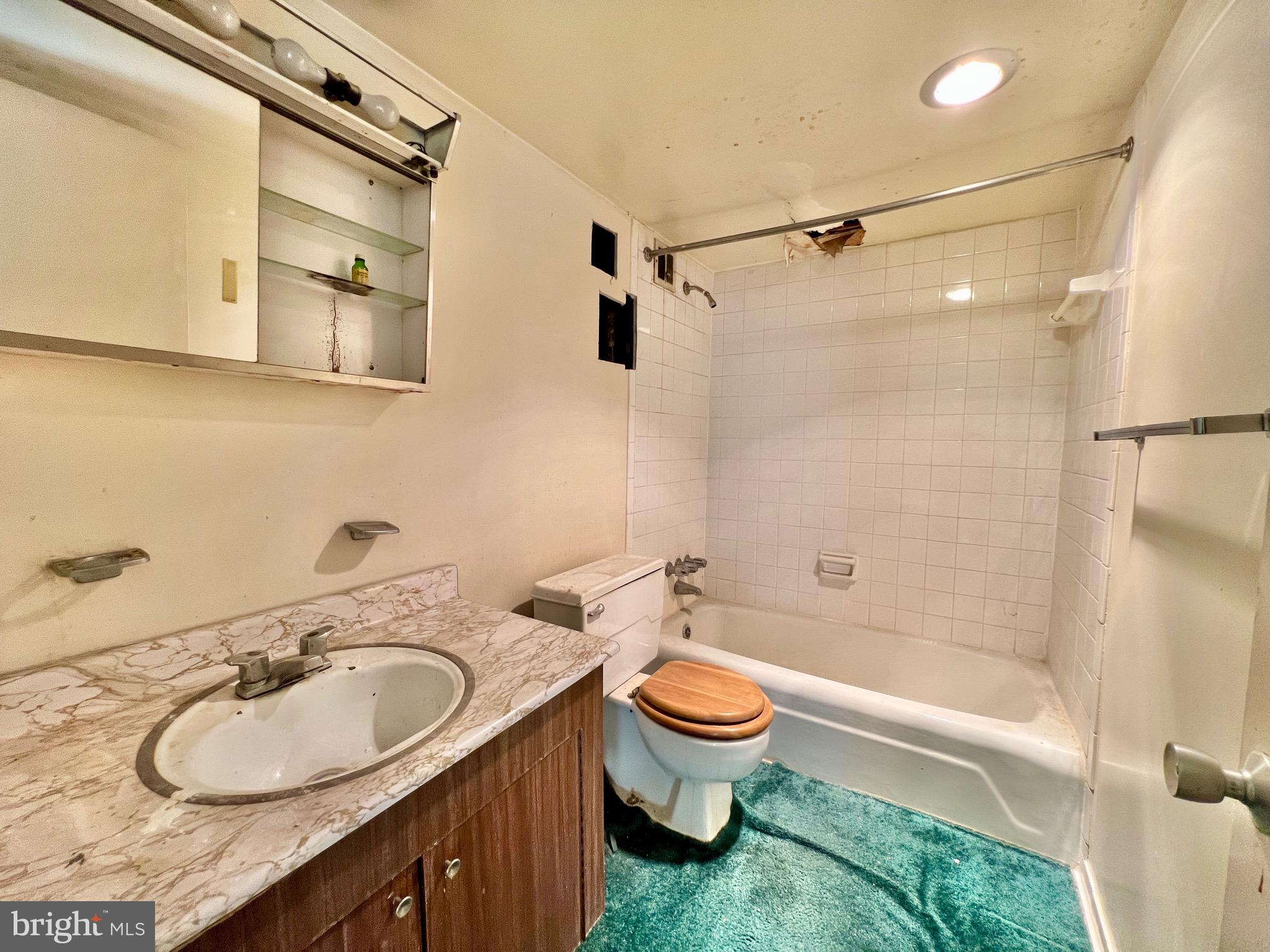 8830 Piney Branch Road, Unit 402 Silver Spring, MD 20903 - Photo 17 of 23 a bathroom with a granite countertop sink toilet and shower